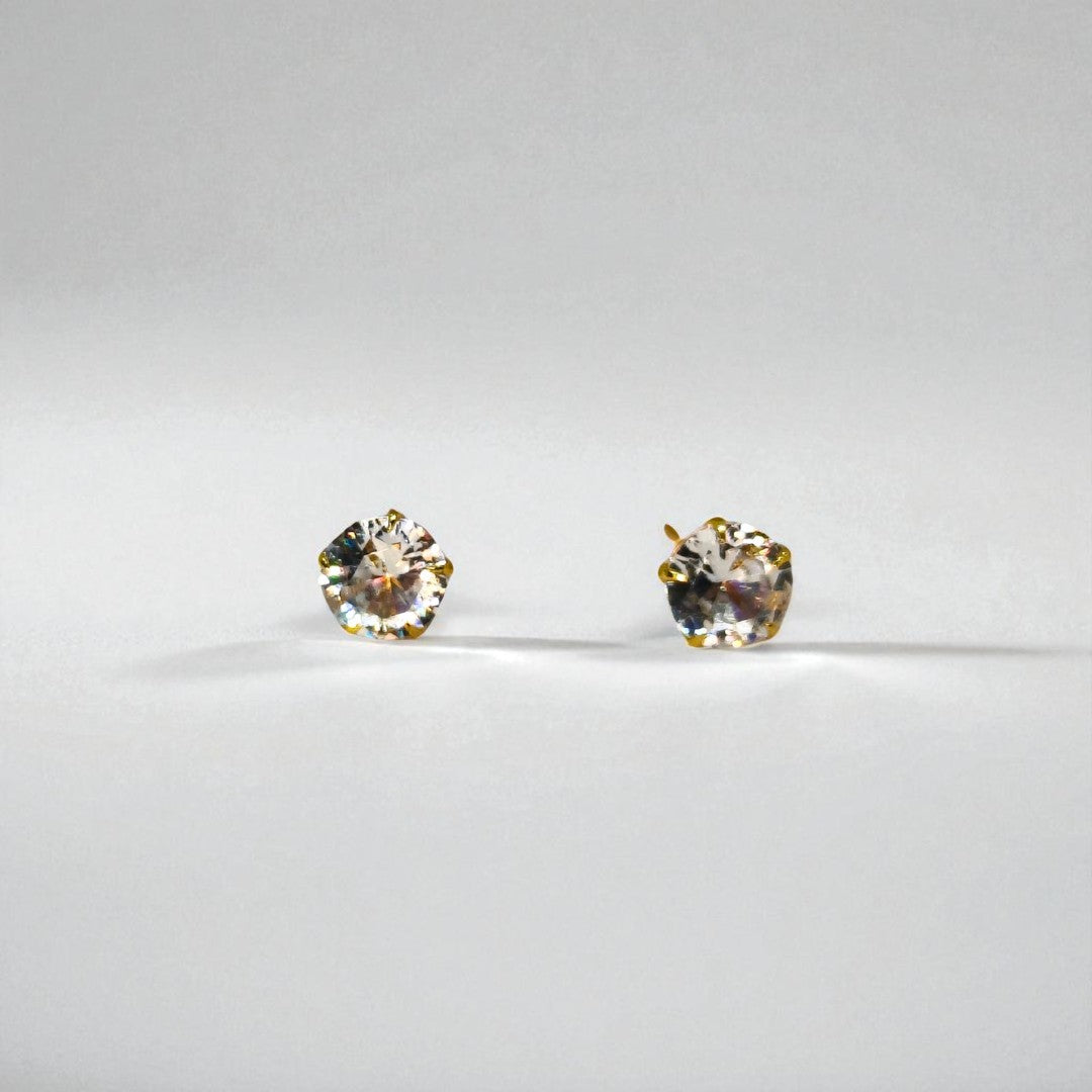 Pair of round Stud Earrings for Women on a light gray background