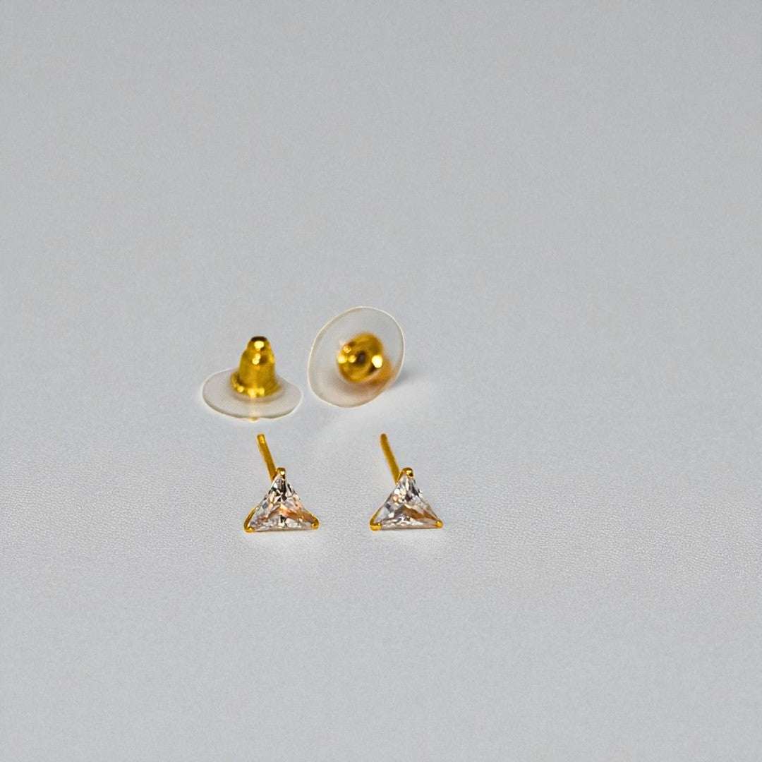 Gold triangle-shaped Stud Earrings for Women with clear stones on a gray background