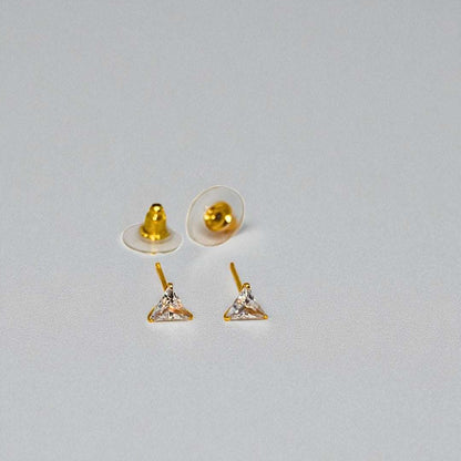 Gold triangle-shaped Stud Earrings for Women with clear stones on a gray background