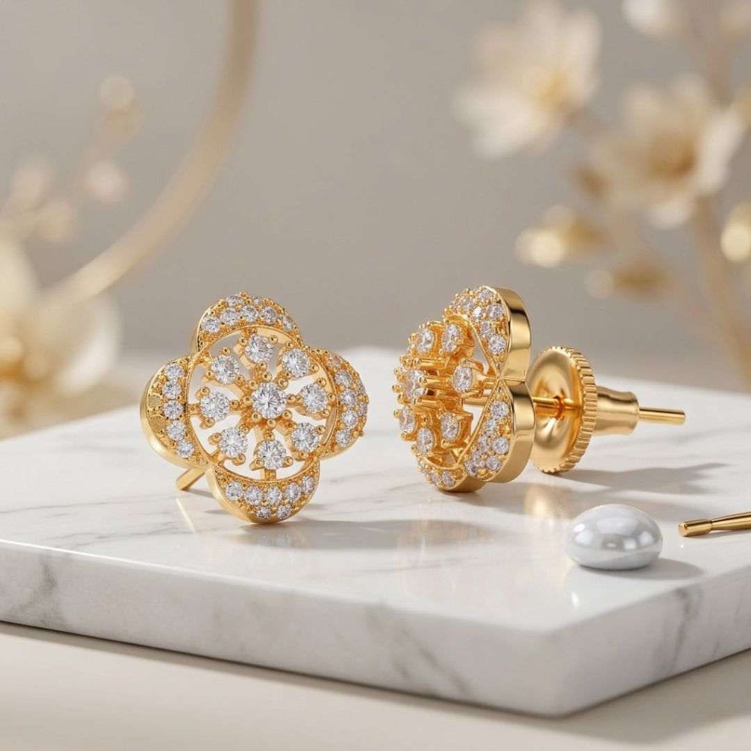 Gold earrings with diamond accents on a marble surface