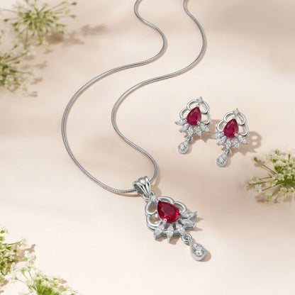 Silver necklace and earring set with pear shaped red stones and small white crystals