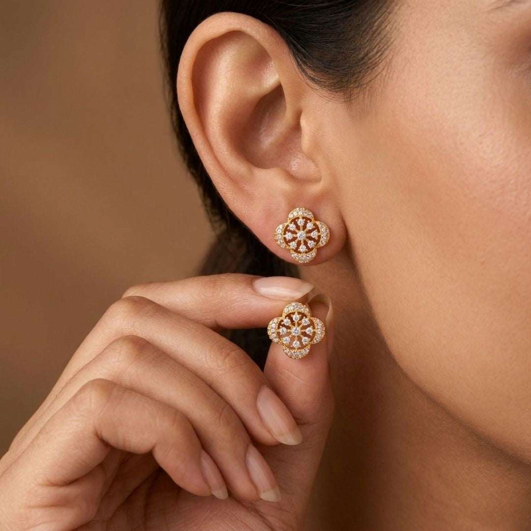 Close-up of a woman wearing gold earrings with a blurred background