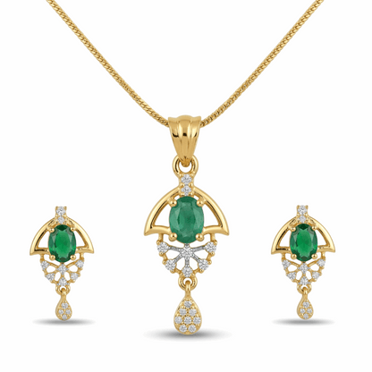 Gold jewelry set with emerald stones on a white background