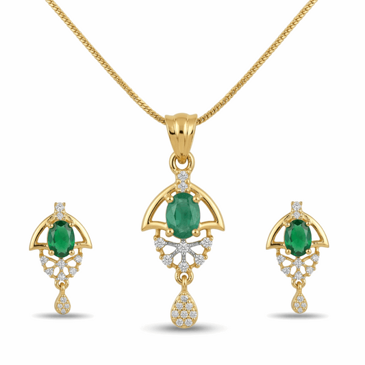 Gold jewelry set with emerald stones on a white background