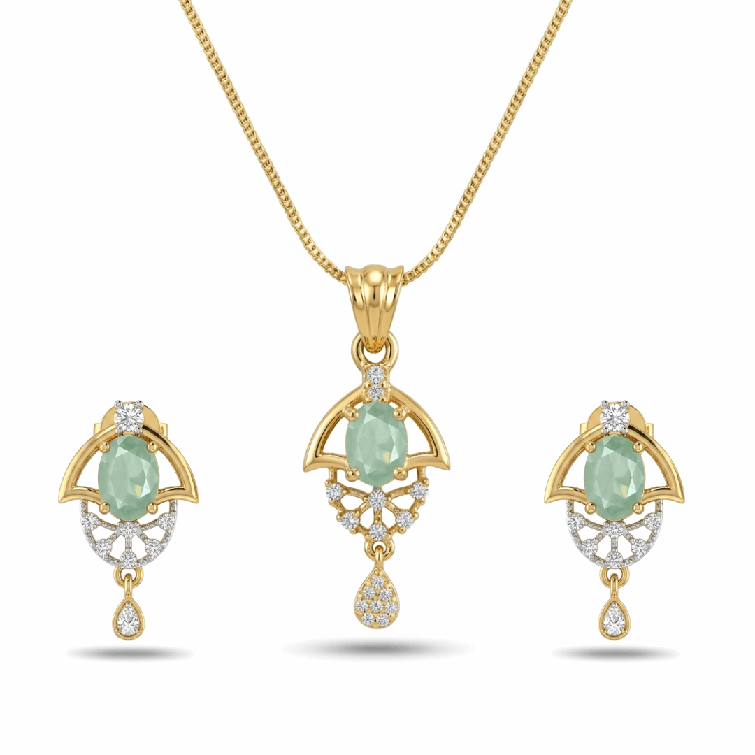 Gold jewelry set with green gemstones on a white background