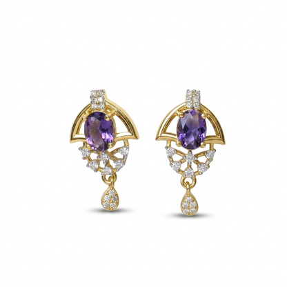 Pair of gold earrings with purple gemstones on a white background