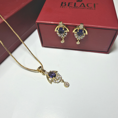 Gold necklace and earrings with purple stones in front of a Belaci box.