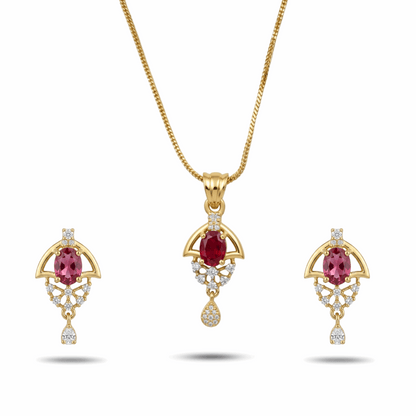 Gold jewelry set with red gemstones on a white background