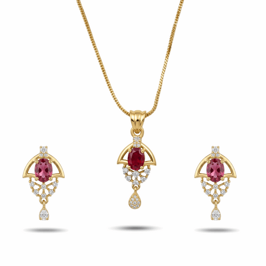 Gold jewelry set with red gemstones on a white background