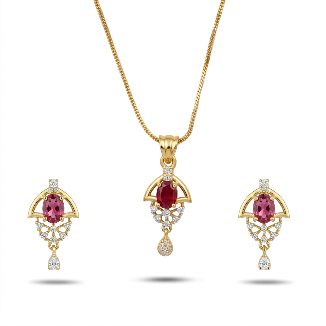 Gold jewelry set with red gemstones on a white background
