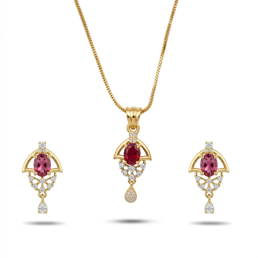 Gold jewelry set with red gemstones on a white background