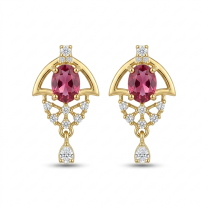 Gold earrings with red gemstones and diamond accents on a white background