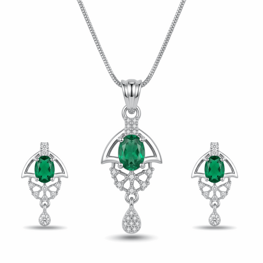 Jewelry set with emerald green gemstones and silver accents on a white background