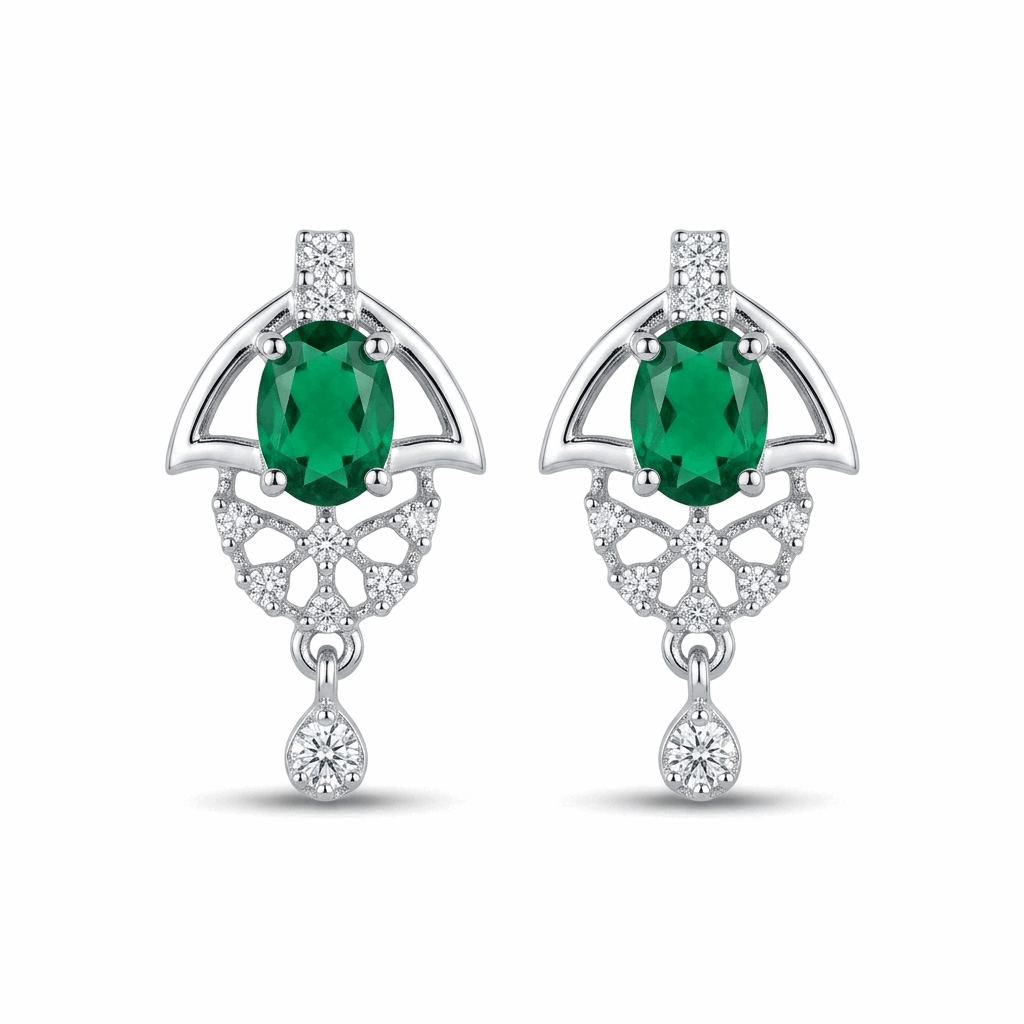 Pair of earrings with green gemstones and silver designs on a white background