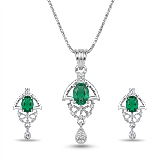 Jewelry set with emerald green gemstones and silver accents on a white background