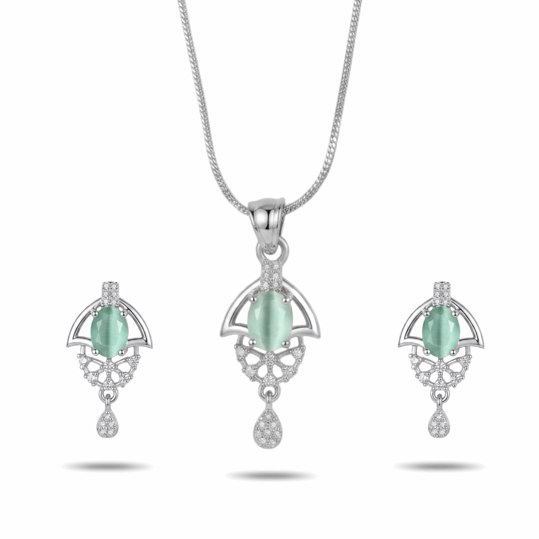 Jewelry set with pendant and earrings featuring green stones on a white background