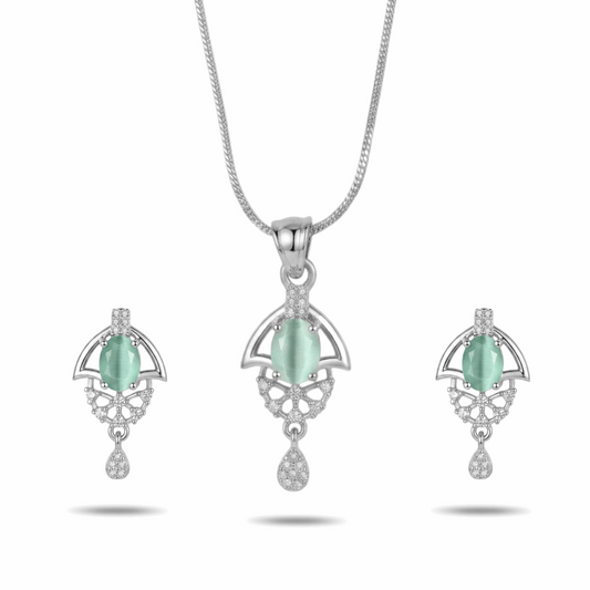 Jewelry set with pendant and earrings featuring green stones on a white background