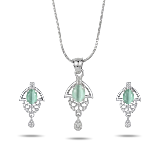 Jewelry set with pendant and earrings featuring green stones on a white background