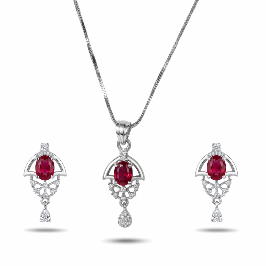 Jewelry set with pendant and earrings featuring red gemstones on a white background