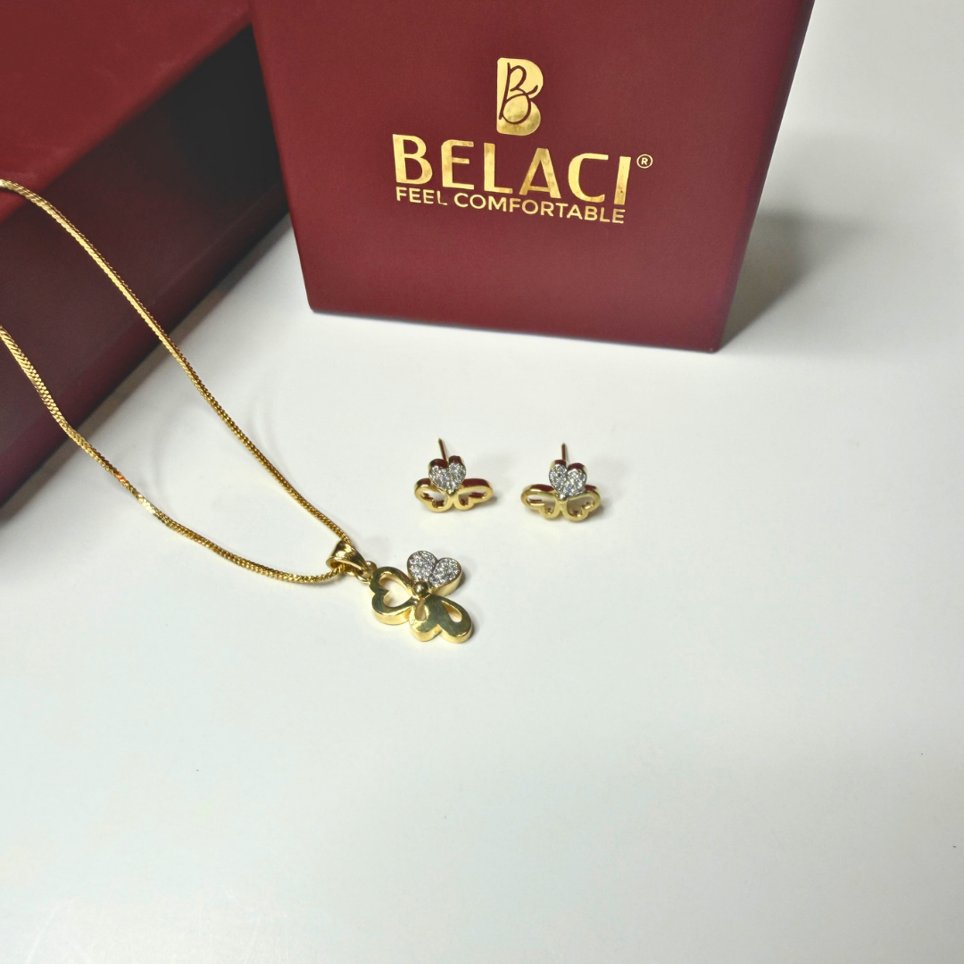 Gold necklace and earrings with BELACI branding on a white surface.