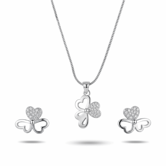 Silver bow-shaped jewelry set with heart details on a white background