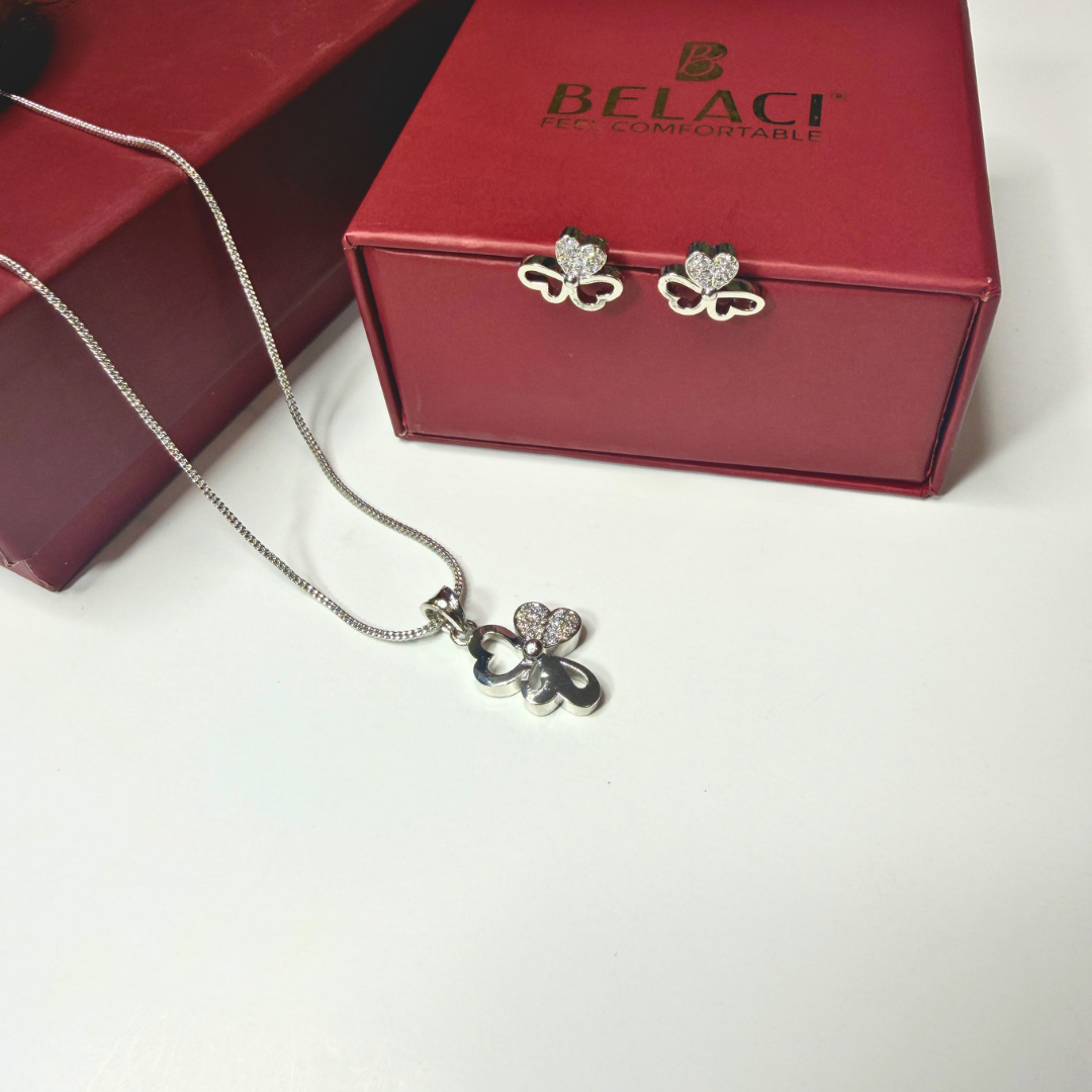 Silver necklace with pendant and butterfly earrings on a Belaci branded box.