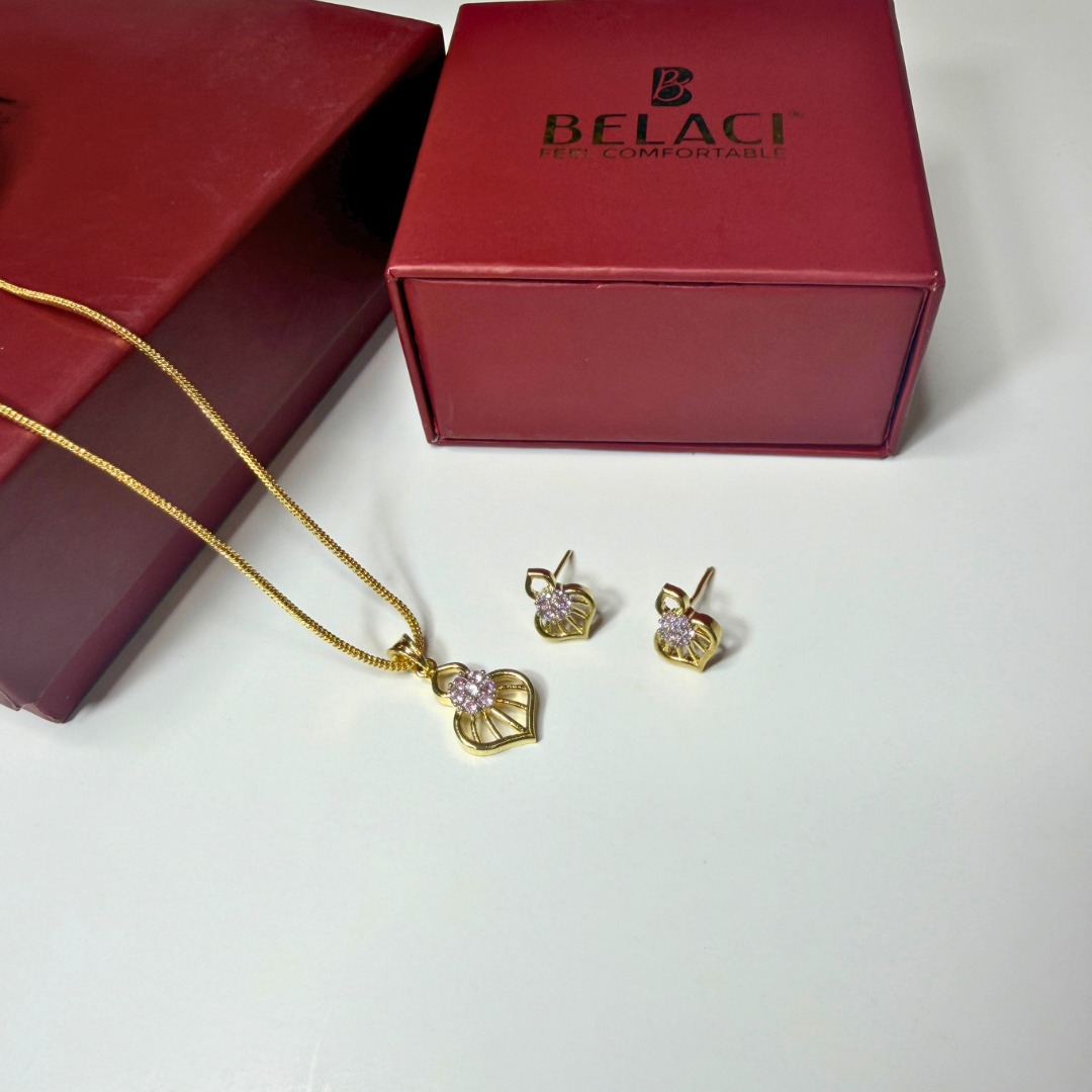 Gold necklace and earrings with a Belaci box on a white background