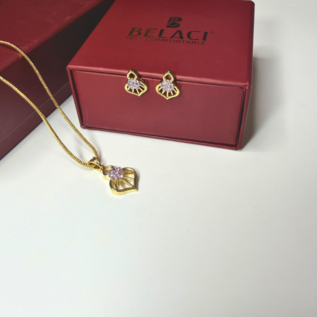 Gold necklace and earrings with pink stones on a Belaci branded box.