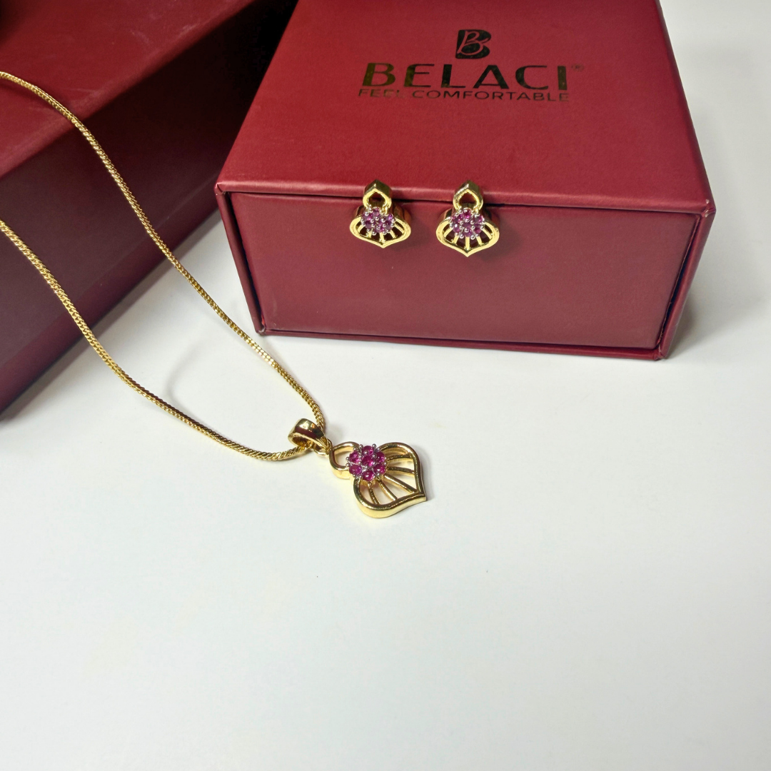 Gold necklace and earrings with pink stones on a white surface, next to a red BELACI box.