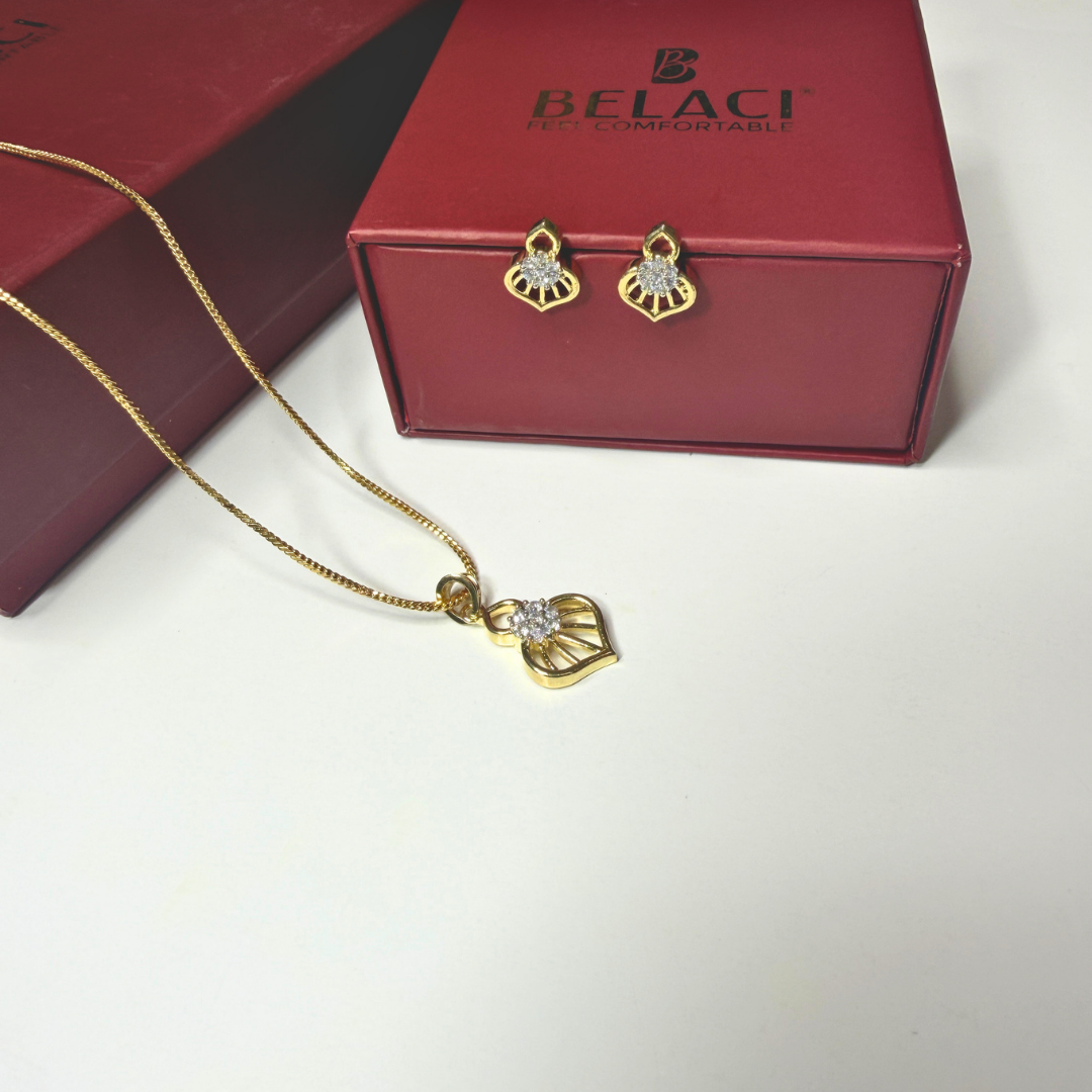 Gold necklace and earrings with BELACI box on a white background