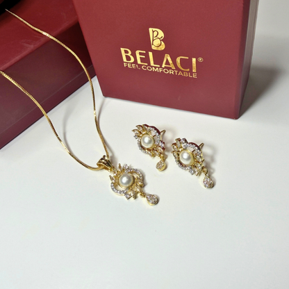 Gold jewelry set with pearls on a white surface, featuring the BELACI brand.