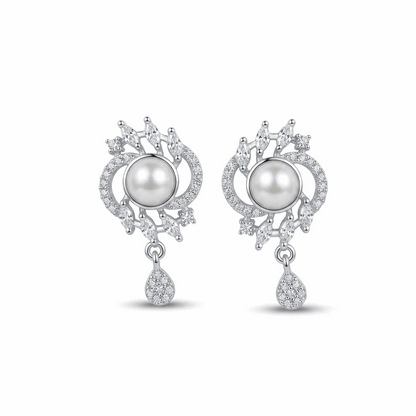 Pair of earrings with pearls and diamond-like stones on a white background