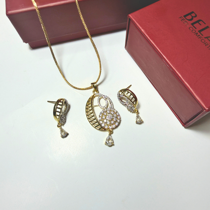 Gold jewelry set with necklace and earrings on a white surface, Beloved brand visible.