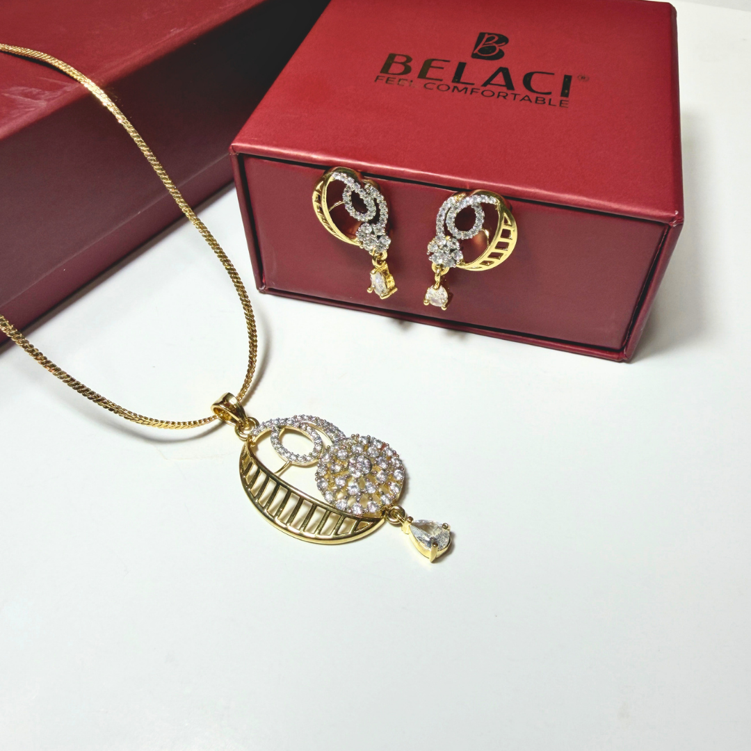 Gold necklace and earrings with BELACI box on a white background