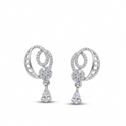Pair of silver earrings with circular designs and teardrop-shaped elements on a white background