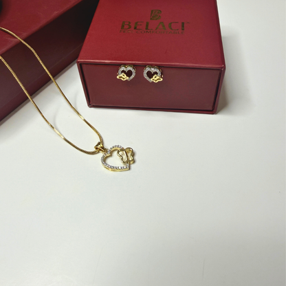 Gold heart-shaped necklace and earrings on a white surface with a red Belaci box in the background.