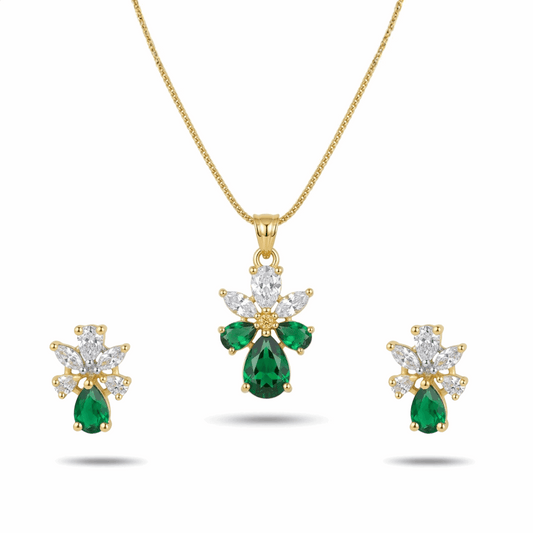 Gold necklace with emerald and diamond pendant and earrings on a white background