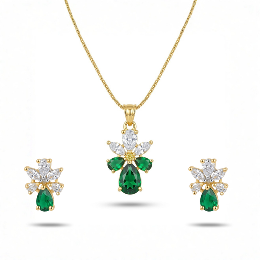 Gold necklace with emerald and diamond pendant and earrings on a white background