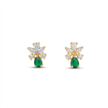 Gold earrings with green gemstones on a white background
