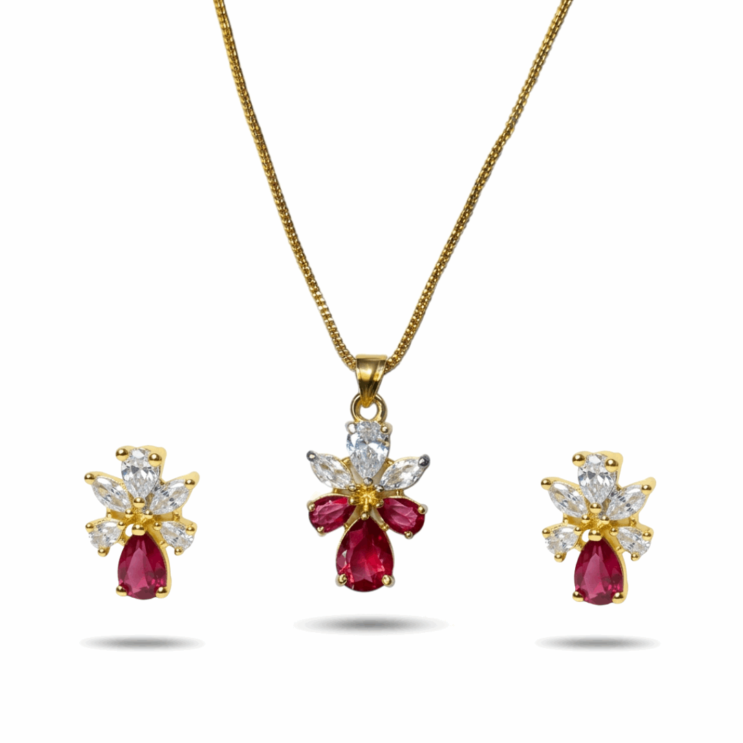 Gold necklace with red gemstones and diamond accents on a white background