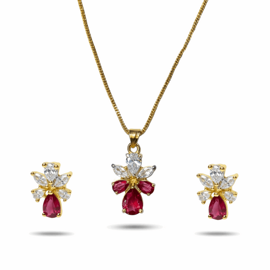 Gold necklace with red gemstones and diamond accents on a white background