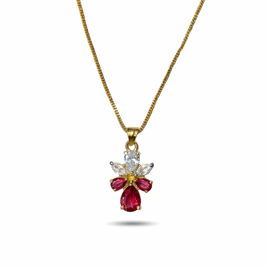 Gold necklace with a red gemstone pendant on a white background