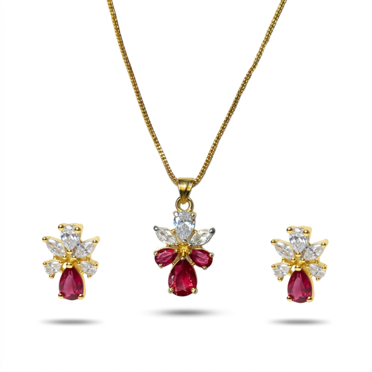 Gold necklace with red gemstones and diamond accents on a white background