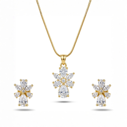 Gold necklace and earrings set with clear gemstones on a white background