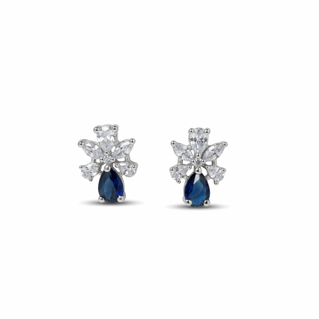 Pair of earrings with blue gemstones and diamond-like stones on a white background