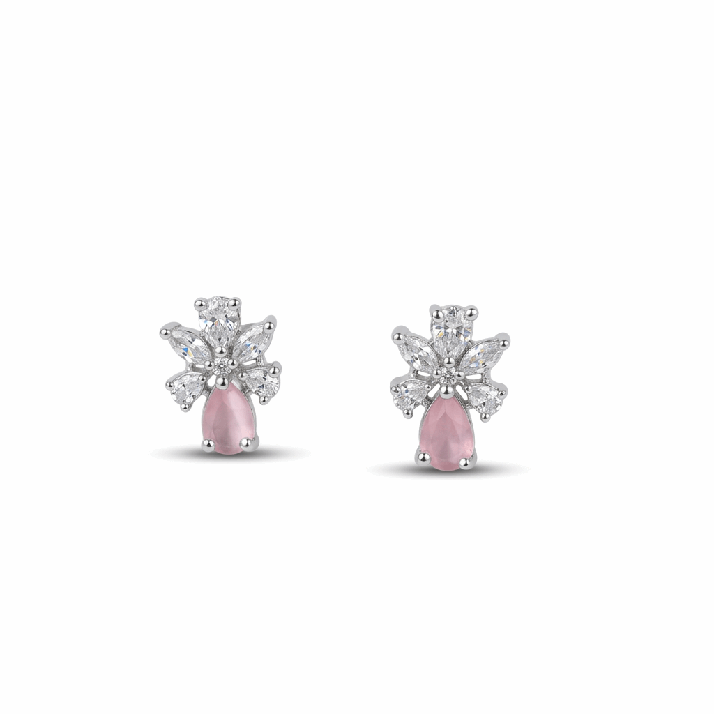 Pair of earrings with pink gemstones and diamond-like elements on a white background