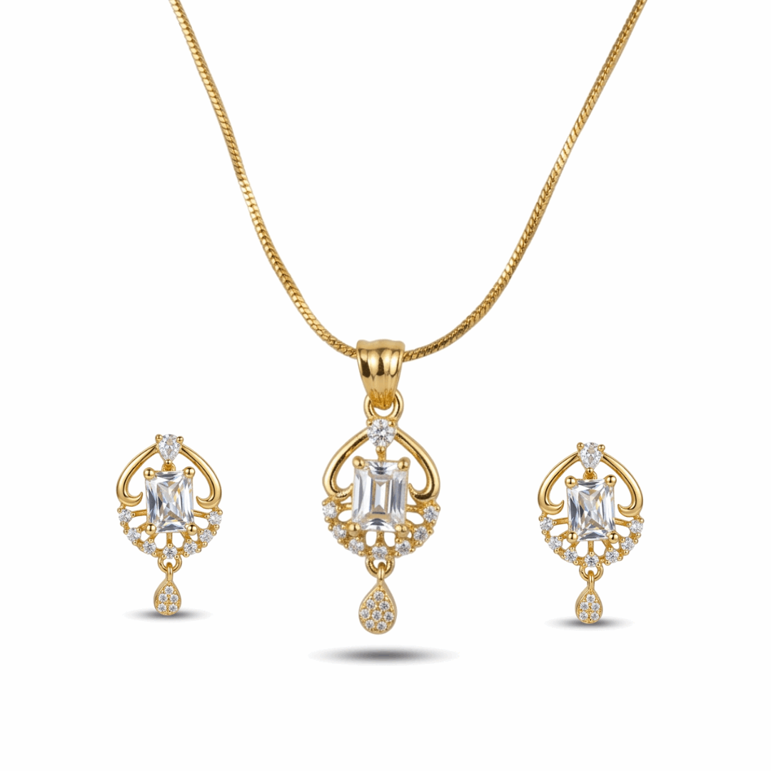 Gold necklace and earrings set on a white background