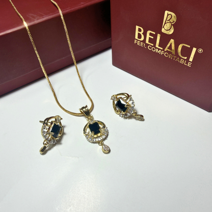 Gold necklace and earrings with black stones on a white surface, Belaci brand visible.
