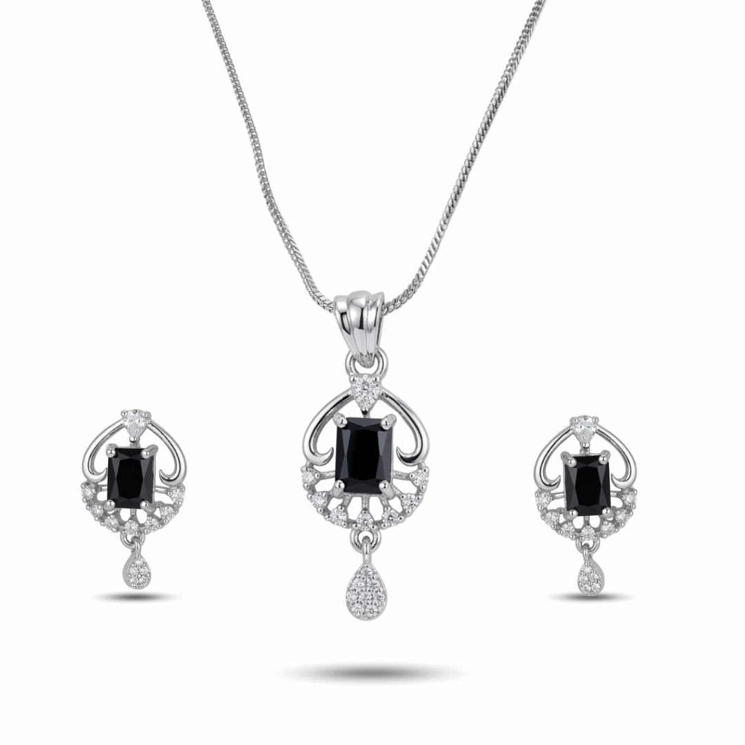 Jewelry set with pendant and earrings featuring black gemstones on a white background