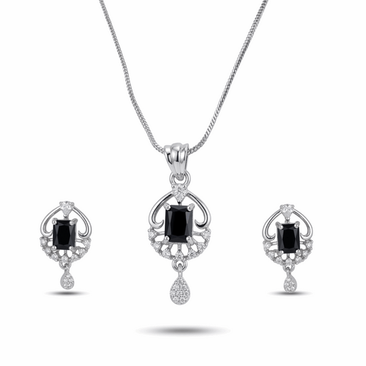 Jewelry set with pendant and earrings featuring black gemstones on a white background